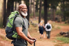 Healthy senior man hiking outside