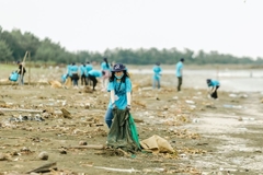 Image A group of people cleaning up trash
