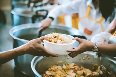 Image hands holding white container with food during food distribution