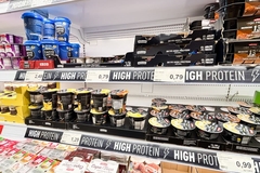 Supermarket shelf with high-protein signs