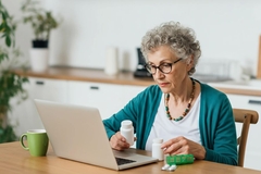 Senior woman shopping supplement online