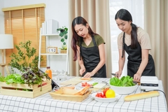 Students cooking with vegetables