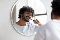 Image happy man brushing his teeth