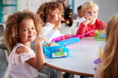 Image Girl eating lunch with classmates