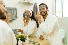 Image couple using facial mask in healthy personal care routine