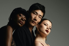 two women and a man posing for a photograph