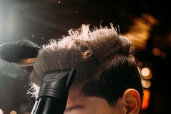 person getting their hair blow dried in a salon
