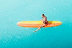 woman on a surfboard in the sun in the sea