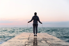 Image Man on a pier jumping rope
