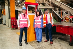 Two men and a woman posing for picture.