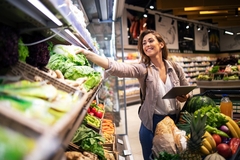 Image Woman choosing fruit and vegetables in the supermarket.
