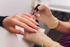 Image woman getting manicure at nail salon