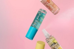 colorful fragrance bottles falling from top to bottom of page