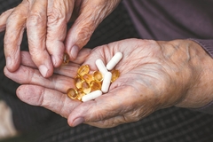Image Elderly woman taking health supplements