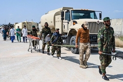 Image military men and doctors walking with vans and stretchers