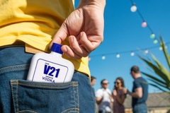 Image PET vodka bottle in back pocket of consumer