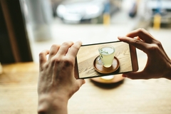 Image Person using their phone to take a picture of tea.