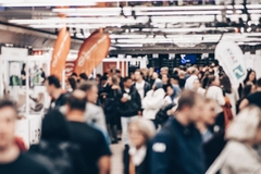 Image blurb people walking in a trade show hall