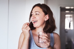 Image woman taking supplement for vaginal microbiome