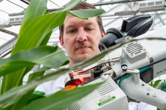 Image scientist with plant and machine