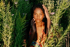 Image woman sitting in a field of flowers