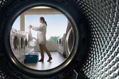 Image scientist standing by washing machines