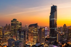 Image Bangkok, Thailand from the air as the sun sets on the city.