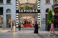 People walking outside a Sephora store.