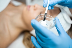 Image An esthetician making a face peel in a bowl.