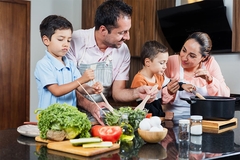Image Latin American family cooking together.