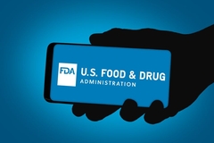 A hand holding a phone saying the US FDA.