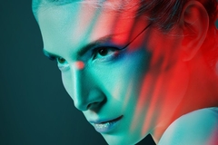 Image futuristic woman with colorful makeup and hard stare