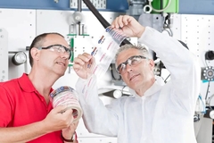 Image two men looking at a label