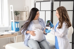 Image Pregnant woman monitoring her blood glucose levels