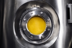 Image round steel bioreactor with yellow protein powder