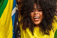 Image woman holding brazilian flag over her head