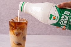 Image pouring cow free drink into a glass of coffee