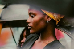 nigerian woman stands outside by car