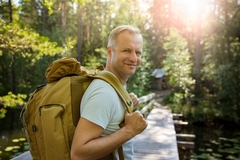 Image Hiker with big backpack traveling in forests