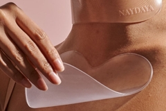 Image A sheet being put on a woman's chest.