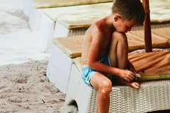 Image boy on the beach sitting