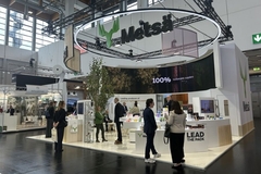 A group of people in front of a booth at a trade show