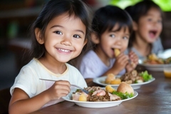 Image Smiling children sit at a table sharing a nutritious breakfast