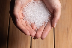 Image two hands holding white beeds