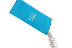 A blue packet with powder coming out of it