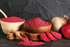 beetroot and its powder in wooden bowls against black background