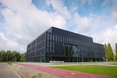 Image rectangular building surrounded by tree and lawn