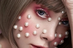 Image A woman with pearl stickers on her face.