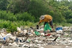 Image man picking waste up from