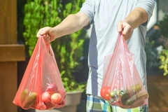 Image man holding plastic bags